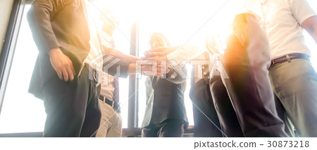 Business people join hand together with sun rays 30873218