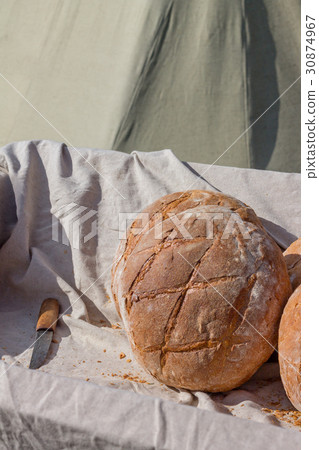 Fresh hearth bread in the cart with knife Fresh hearth bread in the cart with knife 30874967
