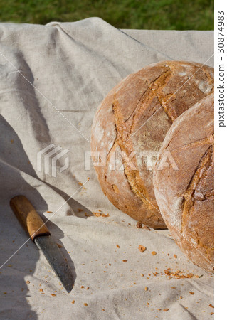 Fresh hearth bread in the cart with knife Fresh hearth bread in the cart with knife 30874983