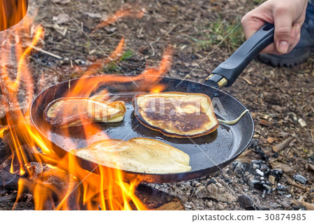 Cooking pancakes in the camp on open air 30874985