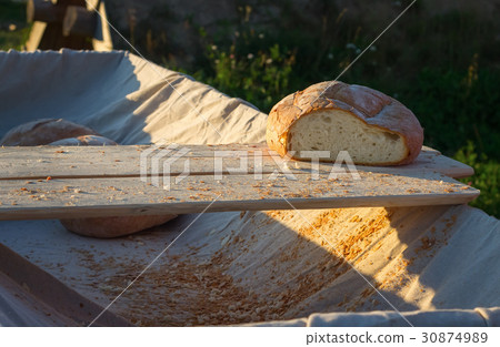 Fresh hearth bread on board in the cart. Fresh hearth bread on board in the cart. 30874989