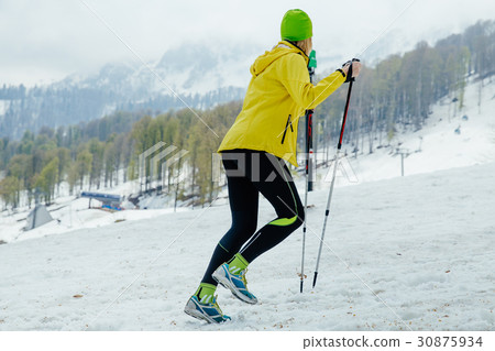 female runner with trekking poles female runner with trekking poles 30875934
