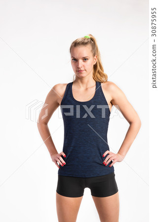 Attractive young fitness woman in blue tank top Attractive young fitness woman in blue tank top 30875955