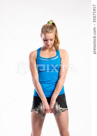Attractive young fitness woman holding dumbell Attractive young fitness woman holding dumbell 30875957