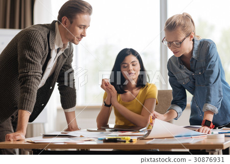 Hard working nice designers concentrating on their 30876931