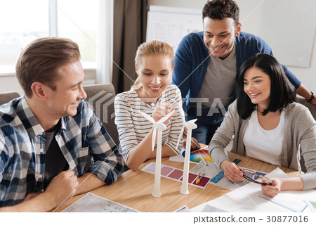 Beautiful curious woman looking at the windmill Beautiful curious woman looking at the windmill 30877016