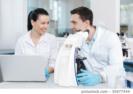 Positive delighted couple of analysts working 30877444