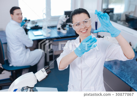 Attractive medical worker raising both hands 30877867