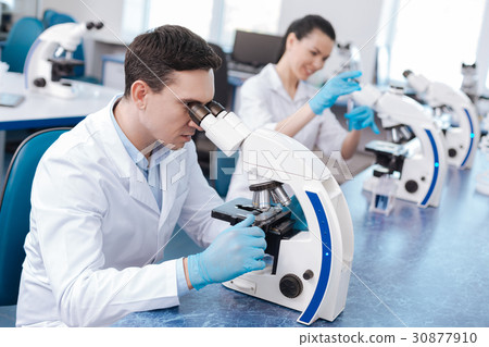 Very attentive lab assistant working with Very attentive lab assistant working with 30877910