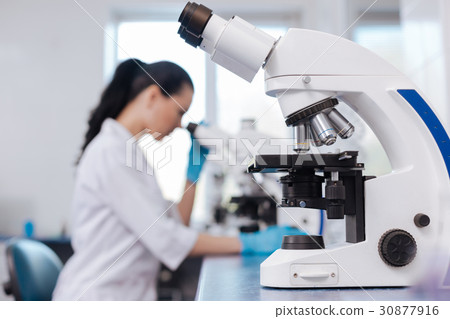 Close up of modern microscope standing on the Close up of modern microscope standing on the 30877916
