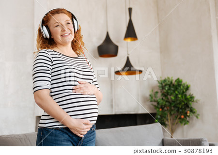 Excited pregnant woman listening to music 30878193