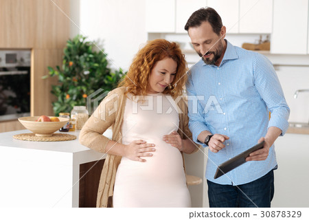Married couple watching media on tablet 30878329