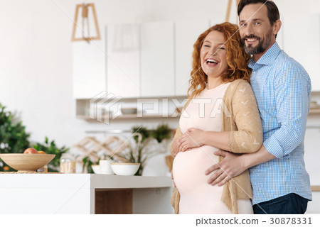 Radiant future parents posing together 30878331