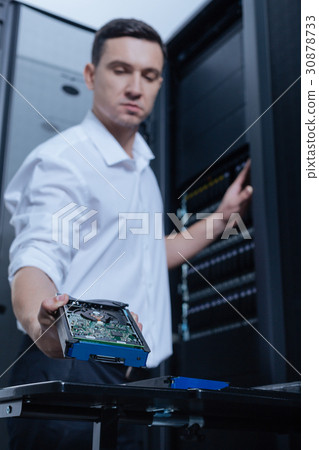 Hard drive being taken by a professional 30878733