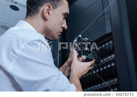 Handsome professional technician working with 30878735