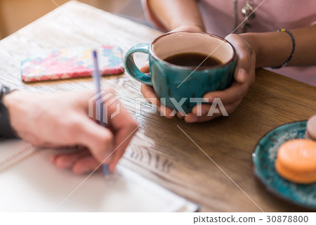 Girl drinking hot beverage near boyfriend Girl drinking hot beverage near boyfriend 30878800