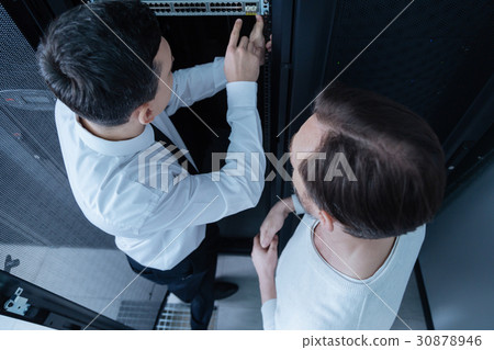 Top view of male technicians deciding what to do Top view of male technicians deciding what to do 30878946