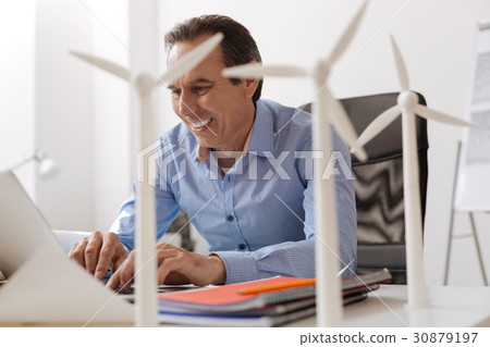 Positive engineer workign on wind turbines project 30879197