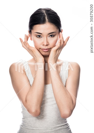 Portrait of Asian young woman looking at camera Portrait of Asian young woman looking at camera 30879200