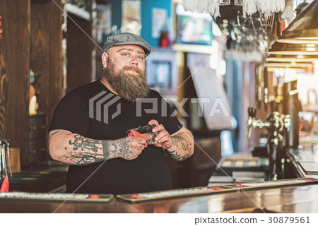 Fat bartender wearing cap laboring in pub Fat bartender wearing cap laboring in pub 30879561