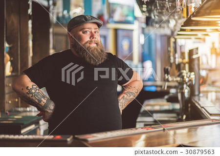 Tattooed barman working in pub Tattooed barman working in pub 30879563