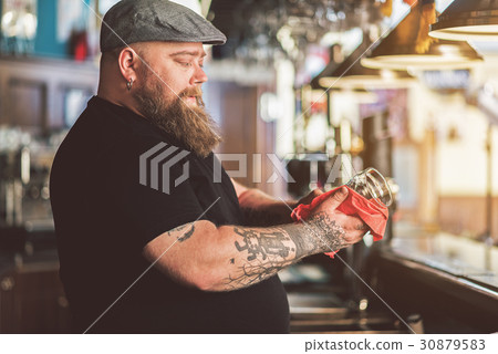 Fat bearded man laboring in pub Fat bearded man laboring in pub 30879583