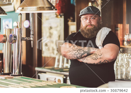Adult bearded man working as bartender Adult bearded man working as bartender 30879642