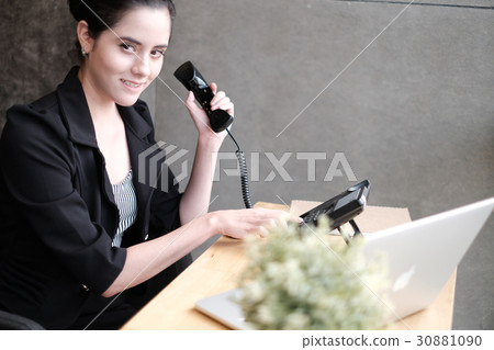 Smilling young businesswoman on phone Smilling young businesswoman on phone 30881090