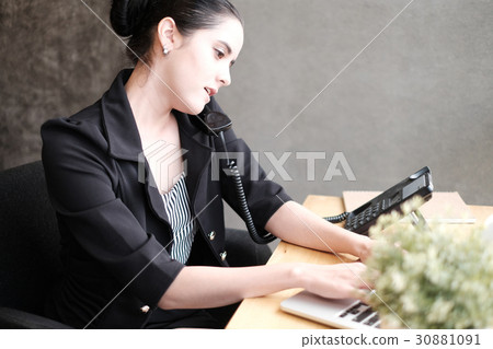 Smilling young businesswoman on phone Smilling young businesswoman on phone 30881091