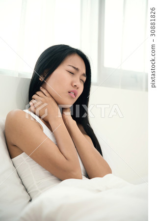 Asian woman having neck pain on her bed. Asian woman having neck pain on her bed. 30881826