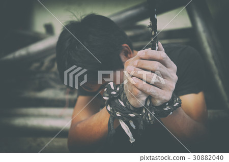 hopeless man hands tied together with rope 30882040