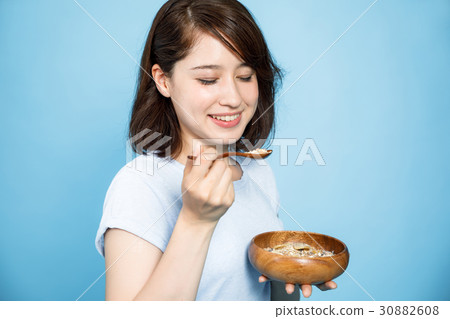 A woman eating cereal A woman eating cereal 30882608