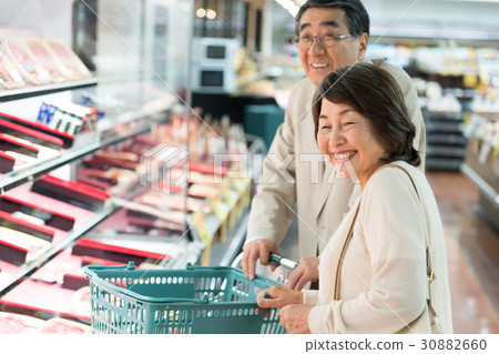 Senior couple shopping at supermarkets 30882660