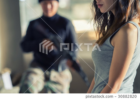 Man in balaclava threatening with gun to woman 30882820