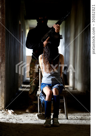 Man in balaclava threatening with gun to woman 30882821
