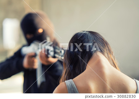 Man in balaclava threatening with gun to woman 30882830