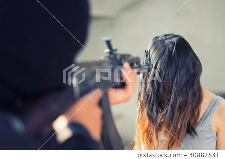 Man in balaclava threatening with gun to woman 30882831