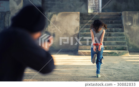 Man in balaclava threatening with gun to woman 30882833