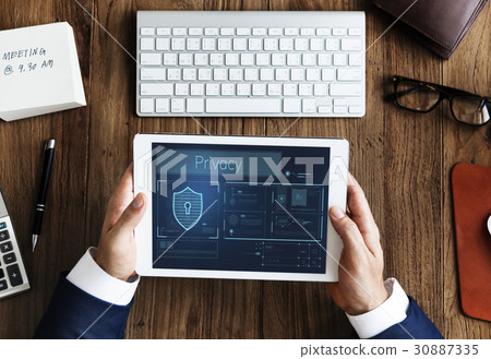 Hands working on digital device network graphic overlay 30887335