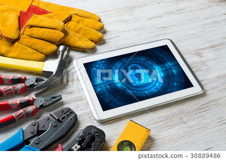 Web security and technology concept with tablet pc on wooden table 30889486
