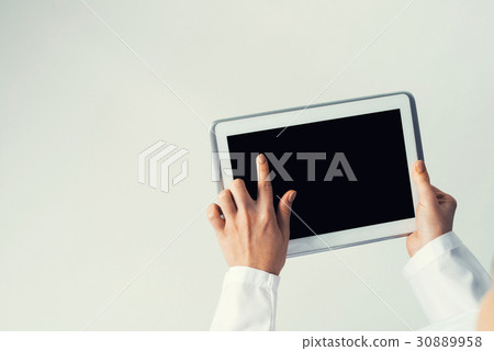 Close of female doctor hands working with tablet pc computer 30889958
