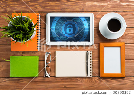 Web security and technology concept with tablet pc on wooden table 30890392