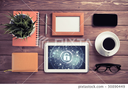 Web security and technology concept with tablet pc on wooden table 30890449
