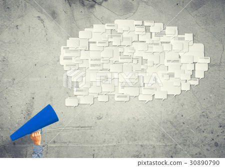 Hand of man holding red paper trumpet against concrete background Hand of man holding red paper trumpet against concrete background 30890790