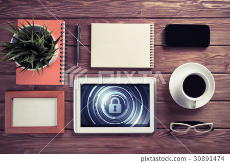 Web security and technology concept with tablet pc on wooden table 30891474