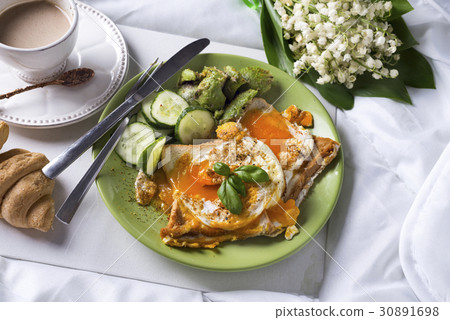 Fried eggs with toasts and tea in bed Fried eggs with toasts and tea in bed 30891698