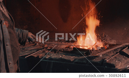 Heating of metal detail in the fire 30892611