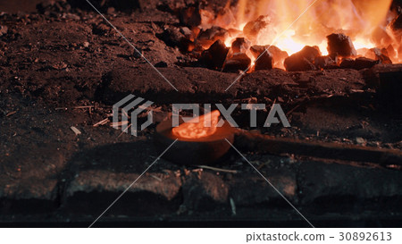 Heated metal part near the fire 30892613