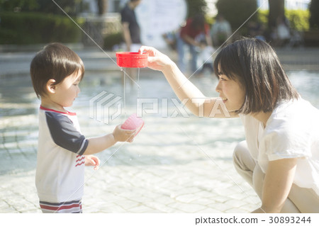 Parent and child playing in the water 30893244