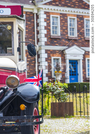 A street corner of a classic car and London 30894205